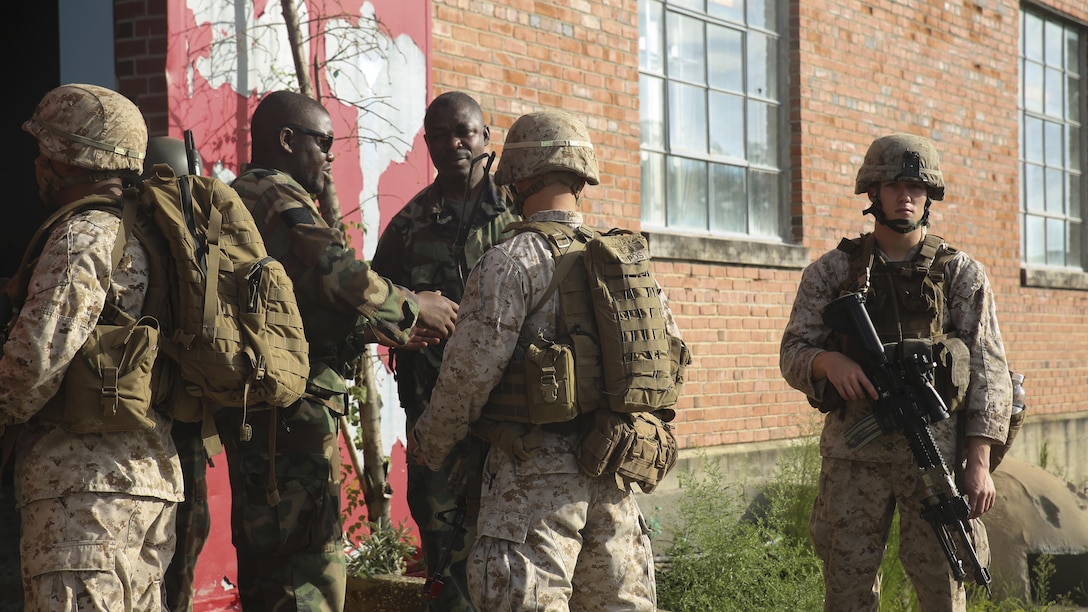 Marines with 1st Battalion, 8th Marine Regiment meet with role players acting as an African army at the Infantry Immersion Trainer at Marine Corps Base Camp Lejeune, N.C., Sept. 30, 2015.  The training is designed to better prepare them for their upcoming deployment with Special Purpose Marine Air-Ground Task Force-Logistical Command Element Africa.  (U.S. Marine Corps Photo by Cpl. Michael Dye/Released)