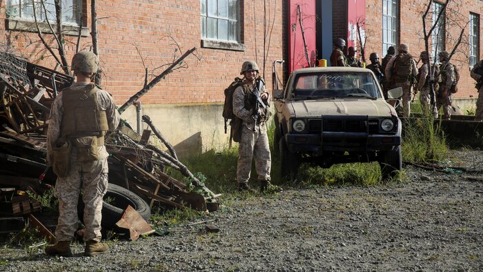 Marines with 1st Battalion, 8th Marine Regiment, enter a fake village to conduct essential training at the Infantry Immersion Trainer at Marine Corps Base Camp Lejeune, N.C., Sept. 30, 2015.  The training is designed to better prepare them for their upcoming deployment with Special Purpose Marine Air-Ground Task Force-Logistical Command Element Africa.  (U.S. Marine Corps Photo by Cpl. Michael Dye/Released) 