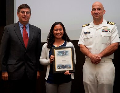 DAHLGREN, Va. - Abby Mohle receives her certificate of achievement from Naval Surface Warfare Center Dahlgren Division (NSWCDD) Technical Director Dennis McLaughlin and NSWCDD Commanding Officer Capt. Brian Durant at the annual command academic awards ceremony, Sept. 21. The NSWCDD engineer - and her husband, Drew - were recognized for completing a master's degree in systems engineering  and commended for commitment to their personal and professional development.