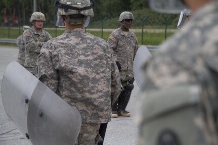 Sgt. 1st Class Marvin McCorvey, a platoon sergeant from the 1st Battalion, 252nd Armor Regiment’s Alpha Company 1st Platoon, gives commands to Soldiers during crowd and riot control training June 15 at the Joint Multinational Readiness Center in Hohenfels, Germany. The training is being conducted in preparation for a peacekeeping mission in Kosovo.