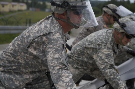 Staff Sgt. Shawn Tart, a squad leader from the 1st Battalion 252nd Armor Regiment, performs the commands given during crowd and riot control training with the rest of his unit June 15 at the Joint Multinational Readiness Center in Hohenfels, Germany. The training is being conducted in preparation for a peacekeeping mission in Kosovo.