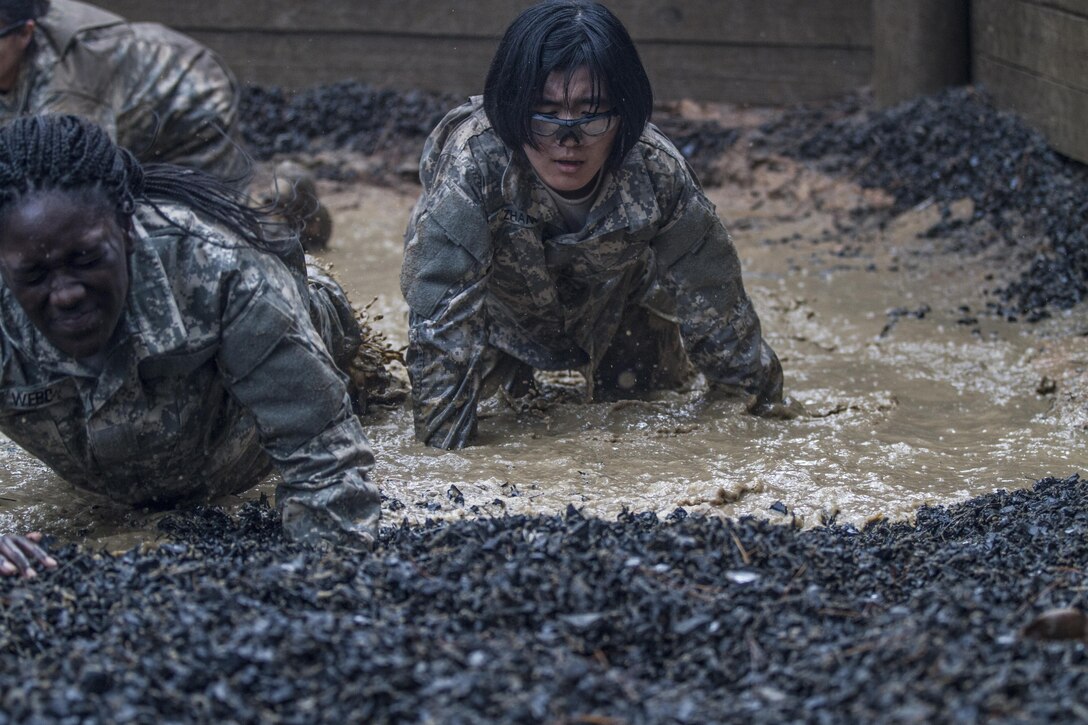 Army Pvt. Tanica Marco, B Company, 3rd Battalion, 34th Infantry Regiment, makes her way through the final water obstacle at the Fit to Win endurance course on Fort Jackson, S.C., Oct. 1, 2015. Marco's unit is currently in their second week of basic combat training. (U.S. Army photo by Sgt. 1st Class Brian Hamilton)