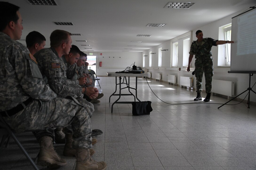 Lt. Col. Nuno Lourenco Alvares Alves de Sousa, a fire phobia instructor for the Portuguese army military police, provides classroom instruction for U.S. Soldiers with the 1st Battalion, 252nd Armor Regiment, during fire phobia training June 16 in Hohenfels, Germany. This exercise is designed to help peacekeeping troops actively go through the steps of what to do when Molotov cocktails are encountered during crowd and riot control.