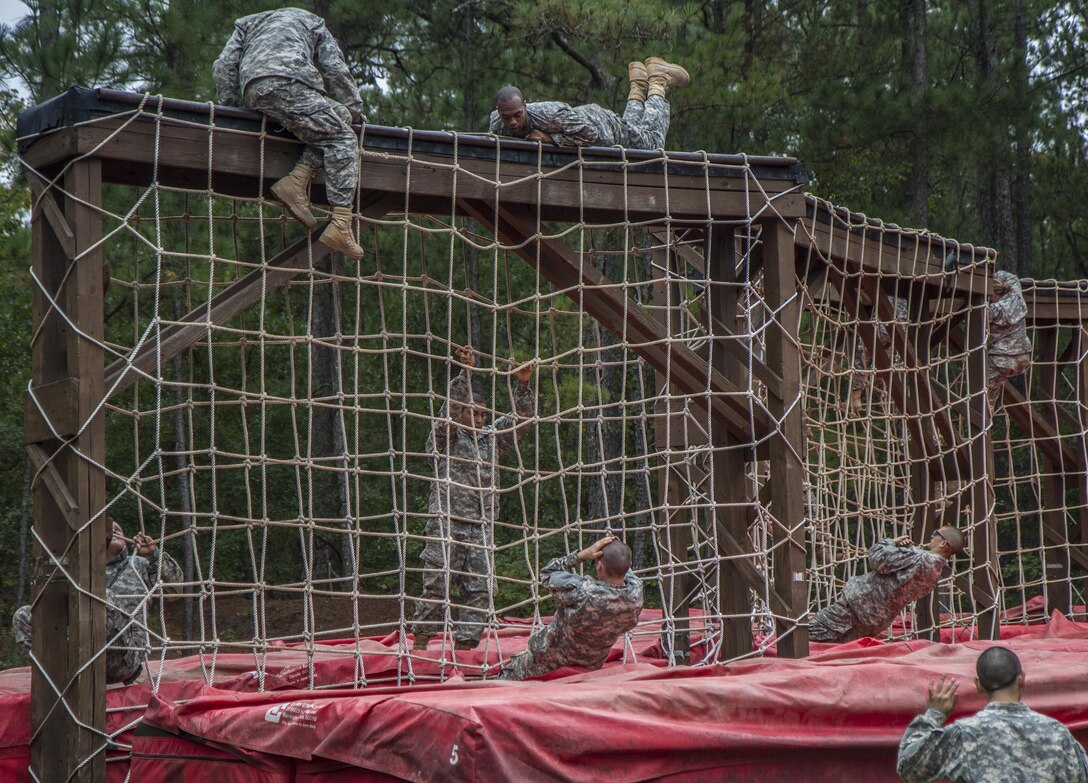 Soldiers in their second week of basic combat training with B Company, 3rd Battalion, 34th Infantry Regiment, tackle the cargo net obstacle at the Fit to Win endurance course on Fort Jackson, S.C., Oct. 1, 2015. (U.S. Army photo by Sgt. 1st Class Brian Hamilton)