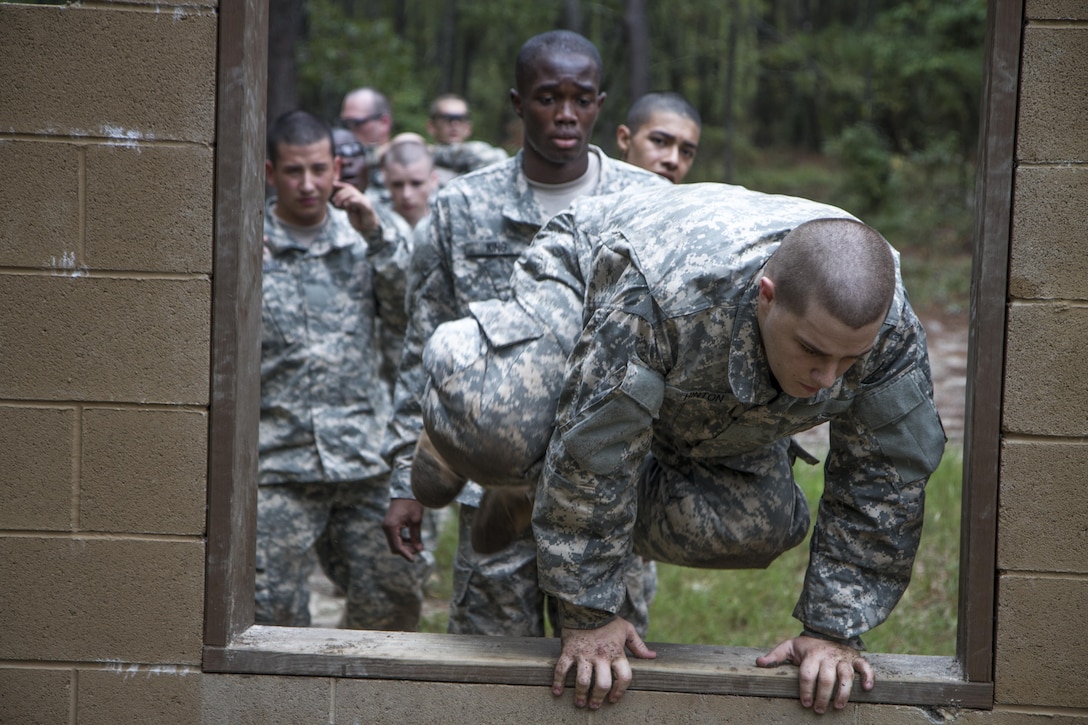 Soldiers in their second week of basic combat training with B Company, 3rd Battalion, 34th Infantry Regiment, line up to leap through the window obstacle at the Fit to Win endurance course on Fort Jackson, S.C., Oct. 1, 2015. (U.S. Army photo by Sgt. 1st Class Brian Hamilton)