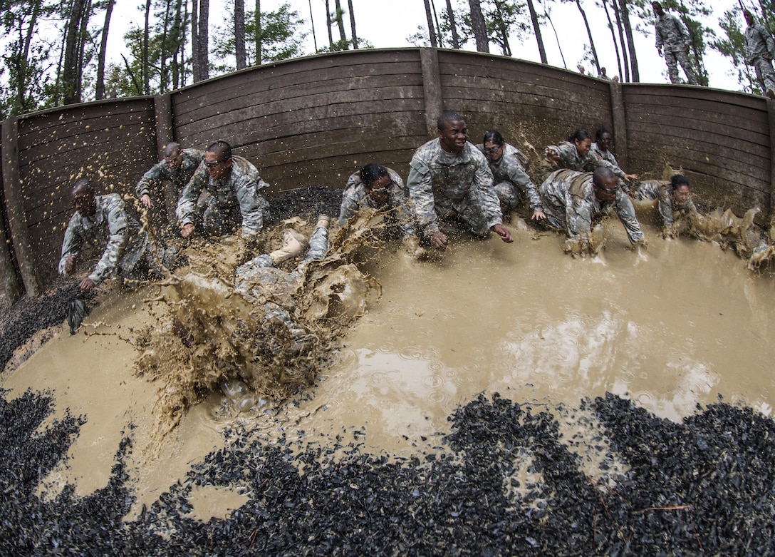 A squad of new Soldiers now in their second week of Basic Combat Training with B Company, 3rd Battalion, 34th Infantry Regiment, tackle the final obstacle of the Fit to Win Endurance course on Fort Jackson, S.C., Oct. 1, 2015. The squad was competing in the Super Squad competition with the winner getting to make a 15 minute phone call home. (U.S. Army photo by Sgt. 1st Class Brian Hamilton)