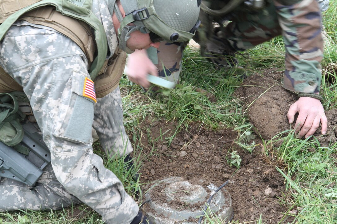 The 666th EOD Company from Jacksonville, Ala., performs various training techniques with the Moldovan a June 21 at the Joint Multinational Readiness Training Center in Hohenfels, Germany. The purpose of the training is to make sure all EOD techs sharpen their individual skills as they prepare for real world missions in Kosovo. (U.S. Army Photo by Sgt. Erick Yates)