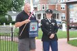 The mayor of Nazareth, Pa., Carl Strye offers hometown hero Sgt. Tonya A. Remick a town banner at her re-enlistment ceremony June 26. The town banner was offered to Tonya as a token of appreciation for the service she has provided to the military and her community. (Army Reserve photo taken by Spc. Stephanie Ramirez/Released)