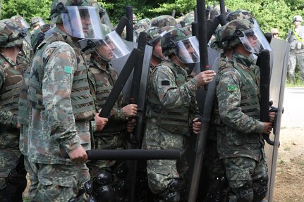 Troops from the Albanian Army take part in a multinational exercise that included forces from the U.S. and Moldova for crowd and riot control June 25 in Hohenfels, Germany. The 30th Armored Brigade Combat Team, an Army National Guard Unit from North Carolina, participated in this training event in preparation for a peacekeeping mission in Kosovo. (U.S. Army Photo by Sgt. Erick Yates)