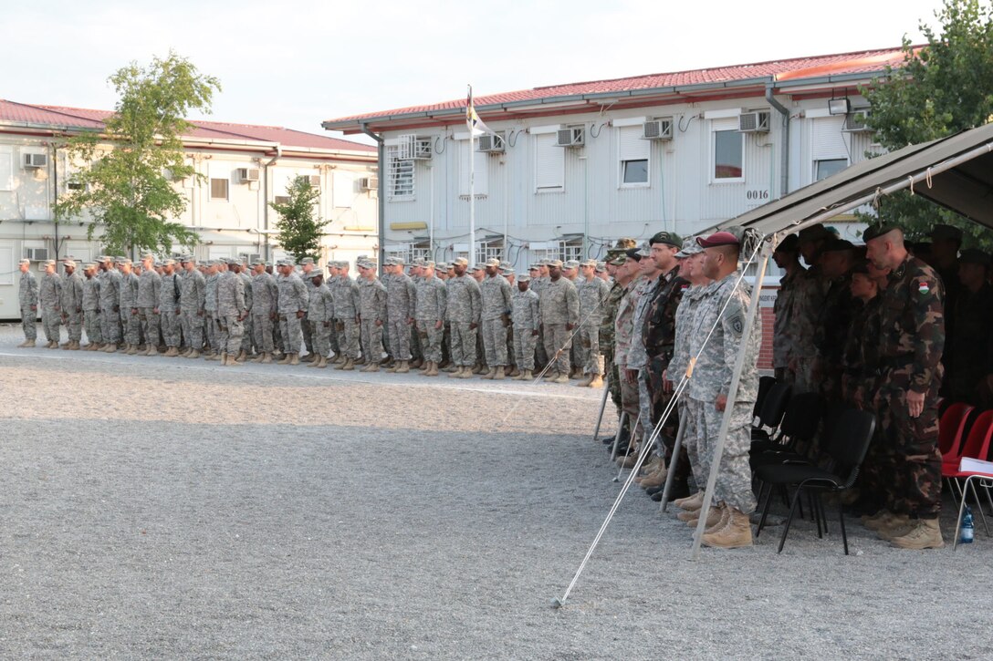 North Carolina Army National Guard Soldiers assigned to 1st Combined Arms Battalion, 252nd Armor Regiment, out of Fayetteville, N.C., stand in formation alongside multinational guests and distinguished visitors during a transition of authority ceremony July 4, 2015, at Camp Marechal de Lattre de Tassigny, Kosovo. During the ceremony, 1-252 assumed responsibility over the Multinational Battle Group-East Forward Command Post, in support of the NATO peace support mission in Kosovo. (U.S. Army photo by Sgt. Gina Russell, Multinational Battle Group-East)