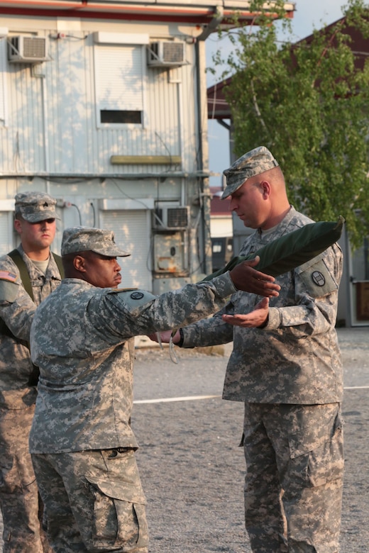 Lt. Col. William J. Gray (right) and Command Sgt. Maj. Charles S. Sanders, the commander and senior noncommissioned officer with 1st Combined Arms Battalion, 252nd Armor Regiment, out of Fayetteville, N.C., uncase the battalion’s colors during a transition of authority ceremony July 4, 2015, at Camp Marechal de Lattre de Tassigny, Kosovo. During the ceremony, the battalion assumed responsibility over the Multinational Battle Group-East Forward Command Post, in support of the NATO peace support mission in Kosovo. (U.S. Army photo by Sgt. Gina Russell, Multinational Battle Group-East)