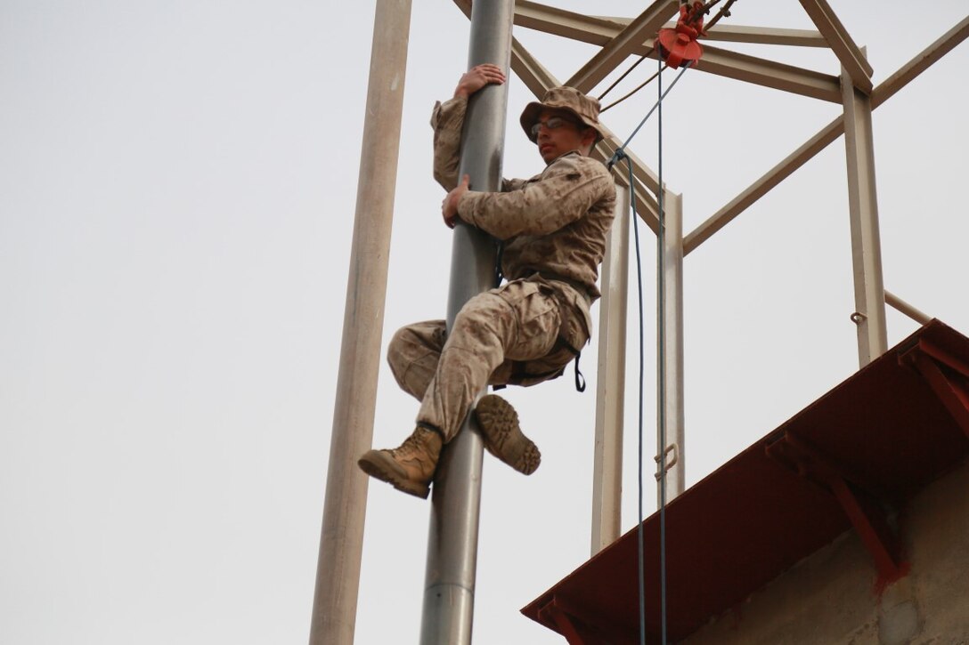 U.S. Marine Cpl. Michael Odintz slides down an obstacle during a portion of a desert survival course with the French 5th Overseas Combined Arms Regiment (RIAOM). Odintz is a scout with Delta Company, 1st Light Armored Reconnaissance Detachment, Battalion Landing Team 3rd Battalion, 1st Marine Regiment, 15th Marine Expeditionary Unit. Elements of the 15th MEU are training with the 5th RIAOM in Djibouti in order to improve interoperability between the MEU and the French military. (U.S. Marine Corps photo by Sgt. Steve H. Lopez/Released)