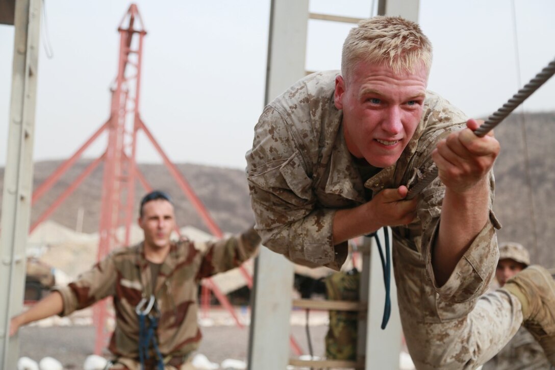 U.S. Marine 1st Lt. Weston Bartkoski balances on an obstacle during a  portion of a desert survival course with the French 5th Overseas Combined Arms Regiment (RIAOM). Bartkoski is a platoon commander with Delta Company, 1st Light Armored Reconnaissance Detachment, Battalion Landing Team 3rd Battalion, 1st Marine Regiment, 15th Marine Expeditionary Unit. Elements of the 15th MEU are training with the 5th RIAOM in Djibouti in order to improve interoperability between the MEU and the French military. (U.S. Marine Corps photo by Sgt. Steve H. Lopez/Released)