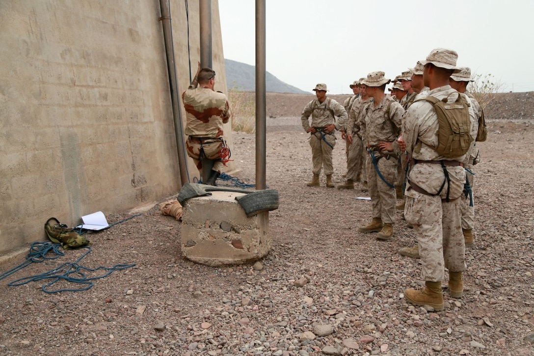 An instructor with the French 5th Overseas Combined Arms Regiment (RIAOM) demonstrates climbing techniques to U.S. Marines with the 15th Marine Expeditionary Unit during a portion of a desert survival course. Elements of the 15th MEU are training with the 5th RIAOM in Djibouti in order to improve interoperability between the MEU and the French military. (U.S. Marine Corps photo by Sgt. Steve H. Lopez/Released)