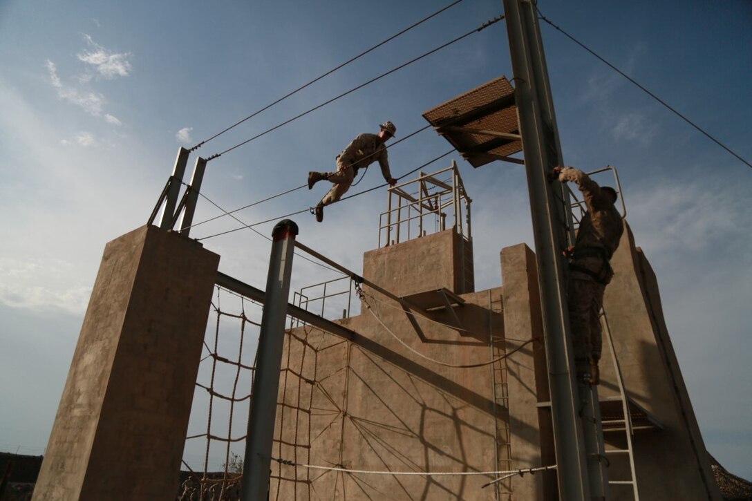ARTA BEACH, Djibouti (Sept. 25, 2015) U.S. Marines with the 15th Marine Expeditionary Unit practice navigating obstacles during a desert survival course alongside the French 5th Overseas Combined Arms Regiment (RIAOM). Elements of the 15th MEU are training with the 5th RIAOM in Djibouti in order to improve interoperability between the MEU and the French military. (U.S. Marine Corps photo by Sgt. Steve H. Lopez/Released)
