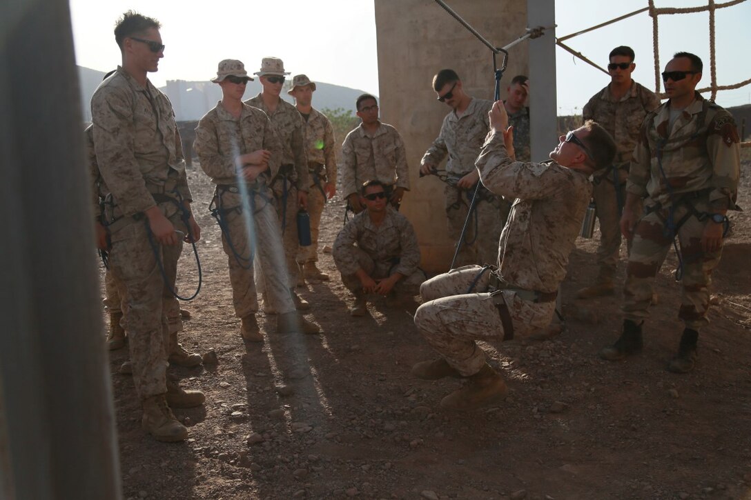 ARTA BEACH, Djibouti (Sept. 25, 2015) U.S. Marine Gunnery Sgt. Matthew Rawson practices securing his harness to a cable obstacle during a desert survival course alongside the French 5th Overseas Combined Arms Regiment (RIAOM). Rawson is a team leader with the 15th Marine Expeditionary Unit’s Force Reconnaissance Detachment. Elements of the 15th MEU are training with the 5th RIAOM in Djibouti in order to improve interoperability between the MEU and the French military. (U.S. Marine Corps photo by Sgt. Steve H. Lopez/Released)