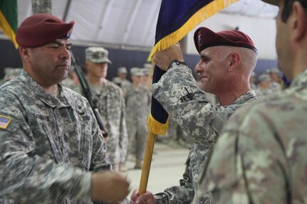 U.S. Army Col. Clint Baker, the commander of 4th Infantry Brigade Combat Team (Airborne), 25th Infantry Division, accepts the NATO colors from his senior noncommissioned officer, Command Sgt. Maj. Ildefonso Barraza, one final time before passing command of Multinational Battle Group-East, to the incoming MNBG-E commander during a transfer of authority ceremony July 9, 2015, at Camp Bondsteel, Kosovo. Soldiers assigned to 4-25th IBCT (Airborne), based out of Joint Base Elmendorf-Richardson, Alaska, have led MNBG-E’s multinational forces since October 2014. (U.S. Army photo by Sgt. Erick Yates, Multinational Battle Group-East)