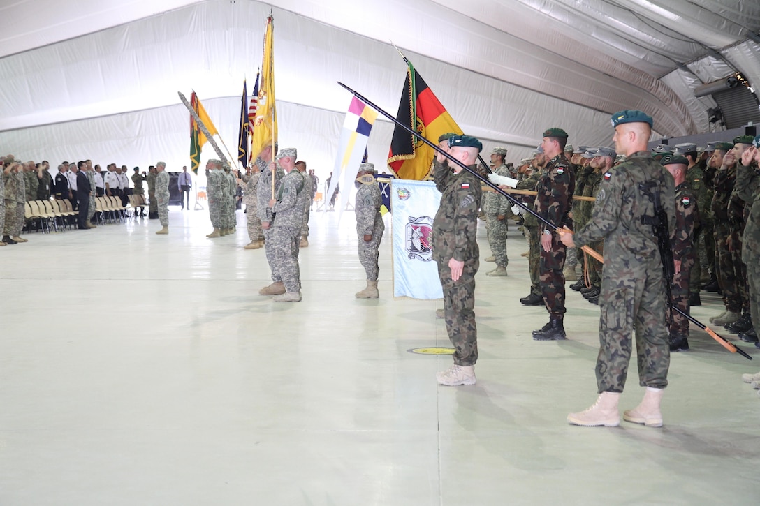 A multinational force presents the colors of the nations and organizations that make up Multinational Battle Group-East, part of NATO’s Kosovo Force, during a transfer of authority ceremony July 9, 2015, at Camp Bondsteel, Kosovo. The 30th ABCT, an Army National Guard unit from North Carolina, will lead a multinational force supporting NATO’s peace mission in Kosovo for approximately nine months. (U.S. Army photo by Sgt. Erick Yates, Multinational Battle Group-East)