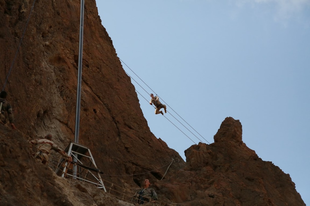 ARTA BEACH, Djibouti (Sept. 27, 2015) A U.S. Marine with the 15th Marine Expeditionary Unit pulls himself across a cable obstacle during a desert survival course with the French 5th Overseas Combined Arms Regiment (RIAOM). Elements of the 15th MEU are training with the 5th RIAOM in Djibouti in order to improve interoperability between the MEU and the French military. (U.S. Marine Corps photo by Sgt. Steve H. Lopez/Released)