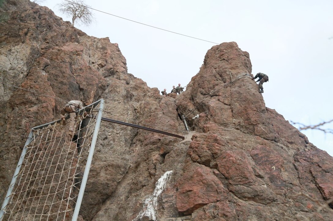 ARTA BEACH, Djibouti (Sept. 27, 2015) U.S. Marines with the 15th Marine Expeditionary Unit navigate obstacles during a desert survival course alongside the French 5th Overseas Combined Arms Regiment (RIAOM). Elements of the 15th MEU are training with the 5th RIAOM in Djibouti in order to improve interoperability between the MEU and the French military. (U.S. Marine Corps photo by Sgt. Steve H. Lopez/Released)