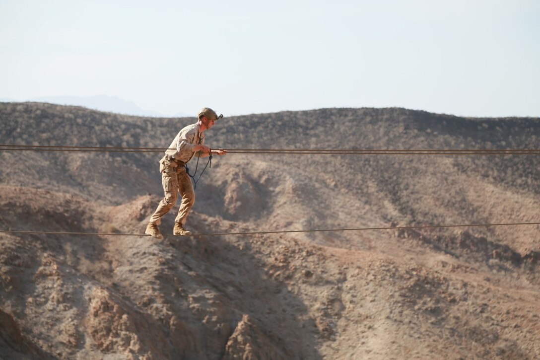 ARTA BEACH, Djibouti (Sept. 28, 2015) U.S. Marine Cpl. Collin Baumann balances on a cable obstacle during a desert survival course alongside the French 5th Overseas Combined Arms Regiment (RIAOM). Baumann is a squad leader with Battalion Landing Team 3rd Battalion, 1st Marine Regiment, 15th Marine Expeditionary Unit. Elements of the 15th MEU are training with the 5th RIAOM in Djibouti in order to improve interoperability between the MEU and the French military. (U.S. Marine Corps photo by Sgt. Steve H. Lopez/Released)