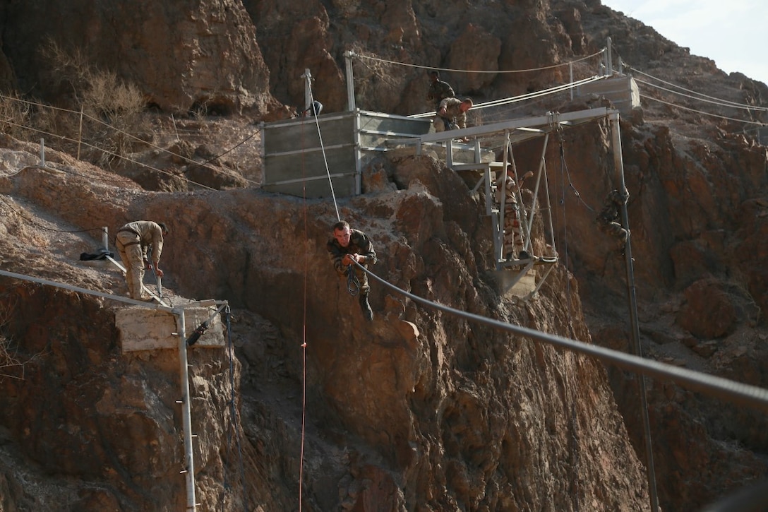 ARTA BEACH, Djibouti (Sept. 28, 2015) U.S. Marines with the 15th Marine Expeditionary Unit navigate through high obstacles alongside soldiers from the French 5th Overseas Combined Arms Regiment (RIAOM) during a desert survival course. Elements of the 15th MEU are training with the 5th RIAOM in Djibouti in order to improve interoperability between the MEU and the French military. (U.S. Marine Corps photo by Sgt. Steve H. Lopez/Released)