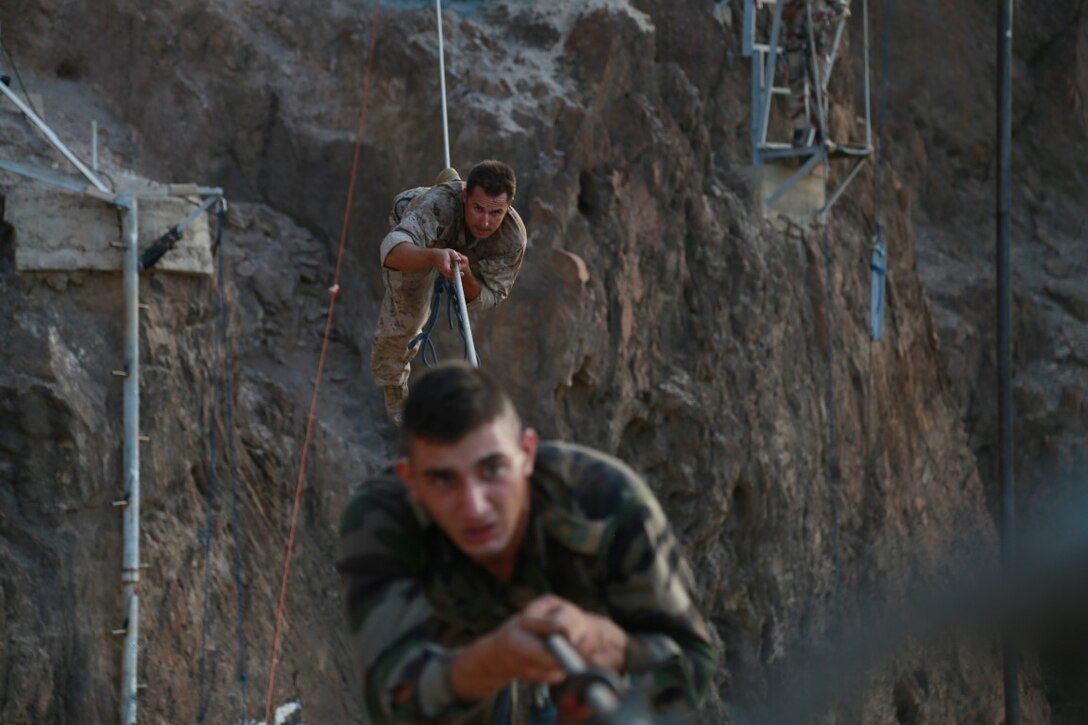 ARTA BEACH, Djibouti (Sept. 28, 2015) U.S. Navy Hospital Corpsman 2nd Class Sean Pientak balances on a high cable obstacle alongside a soldier from the French 5th Overseas Combined Arms Regiment (RIAOM) during a desert survival course. Pientak is a corpsman with the 15th Marine Expeditionary Unit’s Force Reconnaissance Detachment. Elements of the 15th MEU are training with the 5th RIAOM in Djibouti in order to improve interoperability between the MEU and the French military. (U.S. Marine Corps photo by Sgt. Steve H. Lopez/Released)