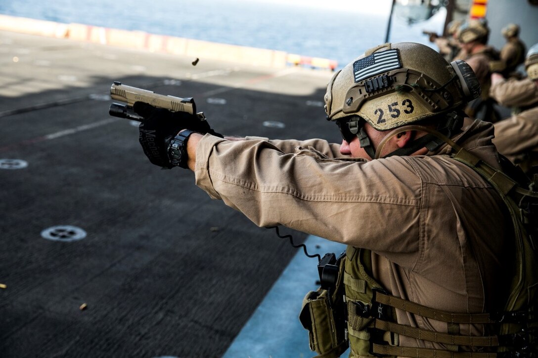 ARABIAN GULF (Oct. 5, 2015) U.S. Marine Cpl. Alex Daigle fires at his target with an M45 1911 A1 pistol during a deck shoot aboard the amphibious assault ship USS Essex (LHD 2). Daigle is a member of the 15th Marine Expeditionary Unit’s Maritime Raid Force. During the shoot, the Marines executed shuttle runs before firing to practice shooting while their bodies were fatigued. The 15th MEU, embarked aboard the ships of the Essex Amphibious Ready Group, is deployed to maintain regional security in the U.S. 5th Fleet area of operations. (U.S. Marine Corps photo by Cpl. Anna Albrecht/Released)