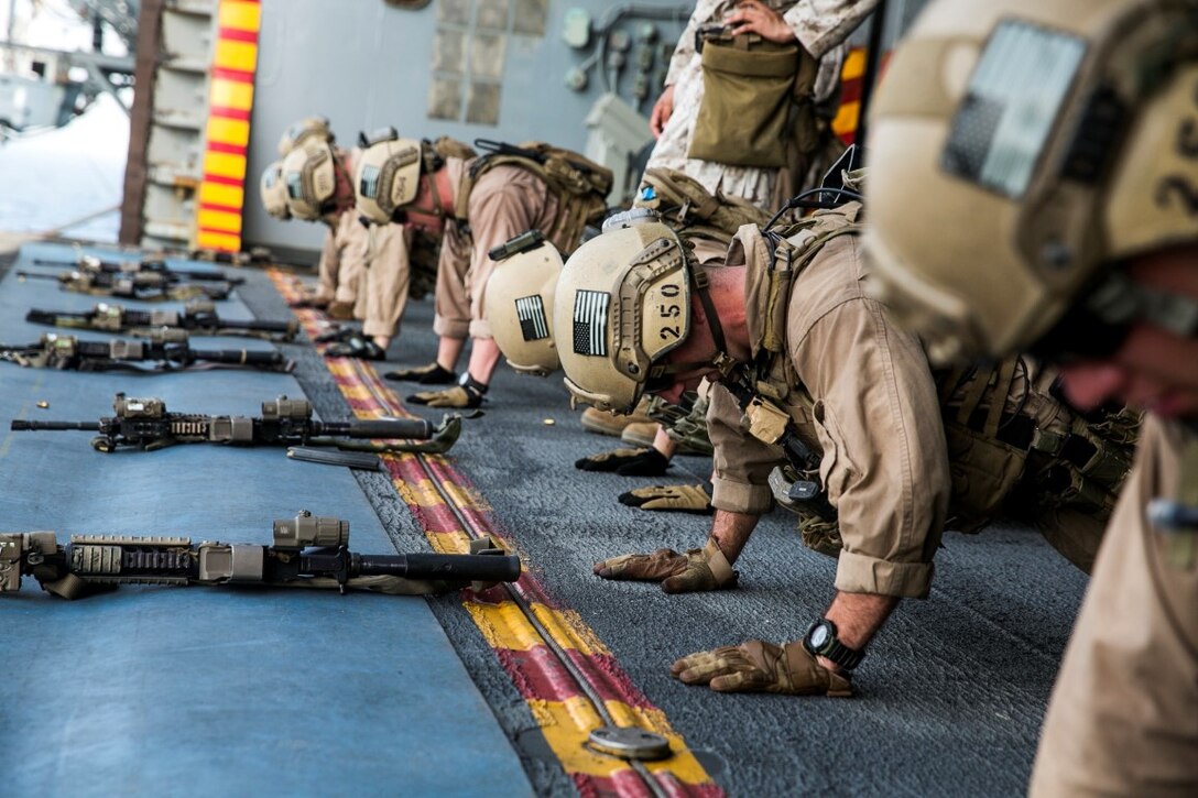 ARABIAN GULF (Oct. 5, 2015) U.S. Marines with the 15th Marine Expeditionary Unit’s Maritime Raid Force execute pushups before they fire during a deck shoot aboard the amphibious assault ship USS Essex (LHD 2). These Marines fatigued their bodies prior to shooting to simulate a combat environment. The 15th MEU, embarked aboard the ships of the Essex Amphibious Ready Group, is deployed to maintain regional security in the U.S. 5th Fleet area of operations. (U.S. Marine Corps photo by Cpl. Anna Albrecht/Released)