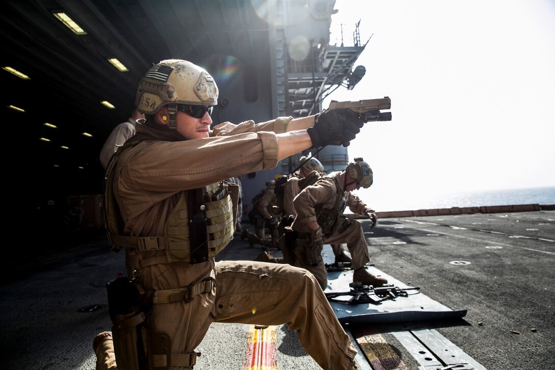 ARABIAN GULF (Oct. 5, 2015) U.S. Marine Sgt. Joshua Mickles aims at his target with an M45 1911 A1 pistol during a deck shoot aboard the amphibious assault ship USS Essex (LHD 2). Mickles is a member of the 15th Marine Expeditionary Unit’s Maritime Raid Force. During the shoot, the Marines executed shuttle runs prior to firing to practice shooting while they’re bodies were fatigued. The 15th MEU, embarked aboard the ships of the Essex Amphibious Ready Group, is deployed to maintain regional security in the U.S. 5th Fleet area of operations. (U.S. Marine Corps photo by Cpl. Anna Albrecht/Released)