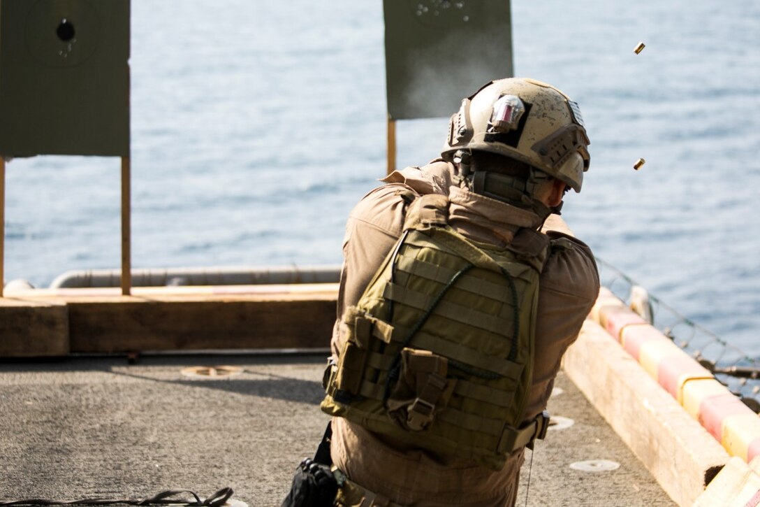 ARABIAN GULF (Oct. 5, 2015) U.S. Marine Sgt. Joshua Mickles fires at his target during a deck shoot aboard the amphibious assault ship USS Essex (LHD 2). Mickles is a member of the 15th Marine Expeditionary Unit’s Maritime Raid Force. During the shoot, the Marines executed shuttle runs prior to firing to practice shooting while their bodies were fatigued. The 15th MEU, embarked aboard the ships of the Essex Amphibious Ready Group, is deployed to maintain regional security in the U.S. 5th Fleet area of operations. (U.S. Marine Corps photo by Cpl. Anna Albrecht/Released)
