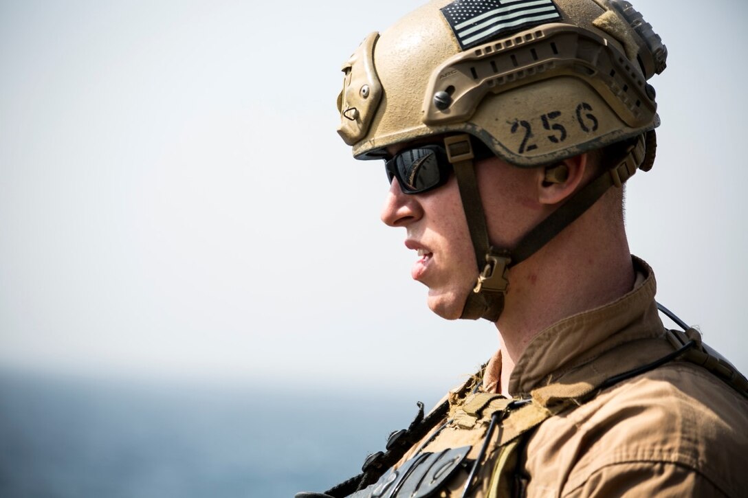 ARABIAN GULF (Oct. 5, 2015) U.S. Marine Cpl. Jake Warden looks at his targets during a deck shoot aboard the amphibious assault ship USS Essex (LHD 2). Warden is a member of the 15th Marine Expeditionary Unit’s Maritime Raid Force. These Marines execute deck shoots frequently to sustain their speed and accuracy on ship. The 15th MEU, embarked aboard the ships of the Essex Amphibious Ready Group, is deployed to maintain regional security in the U.S. 5th Fleet area of operations. (U.S. Marine Corps photo by Cpl. Anna Albrecht/Released)