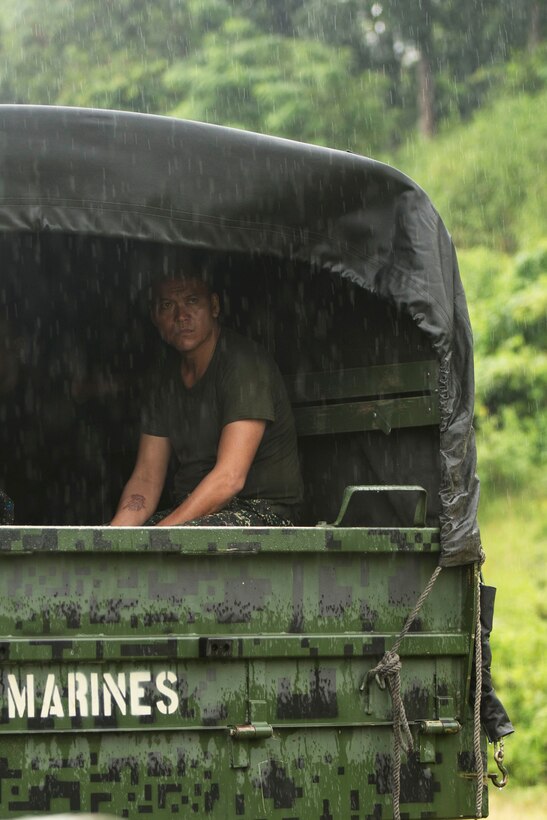 Philippine marine Staff Sgt. Sanny Tagalog sits in the back of a KM-250, 2 1/2-ton utility vehicle as it rains during Amphibious Landing Exercise 2015 at Crow Valley, Philippines, Oct. 2, 2015. U.S. Marine Corps photo by Staff Sgt. Carl Atherton