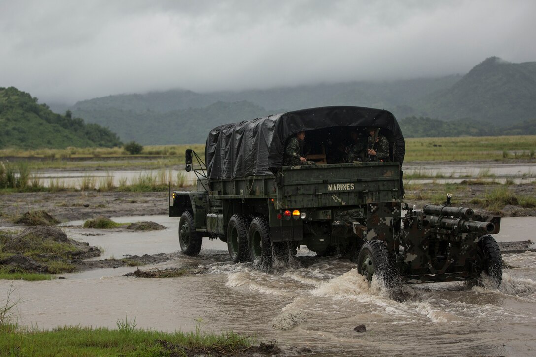 Philippine marines transport an M101 105mm howitzer with a KM-250 Utility Vehicle to the artillery range during Amphibious Landing Exercise 2015 at Crow Valley, Philippines, Oct. 2, 2015. U.S. Marine Corps photo by Staff Sgt. Carl Atherton
