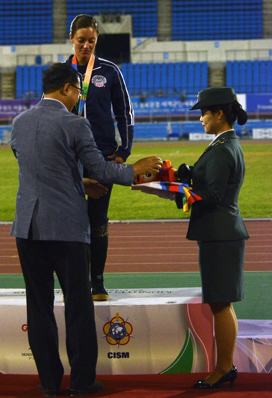 U.S. Army Sgt. Elizabeth Wasil, center, receives the first gold medal for Team USA at the 6th Military World Games in Mungyeong, South Korea, Oct. 4, 2015. She placed first in Women's Shot Put Para. DoD photo by Gary Sheftick