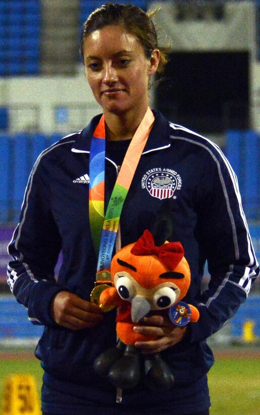 U.S. Army Sgt. Elizabeth Wasil reflects after receiving the first gold medal for Team USA at the 6th Military World Games in Mungyeong, South Korea, Oct. 4, 2015. Wasil placed first in Women's Shot Put Para. In her left hand is the games' mascot, Haeraoni, presented to all medalists. DoD photo by Gary Sheftick