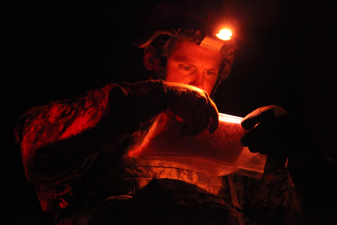 Army Staff Sgt. Andrew Fink plots grid coordinates during the Army’s Best Warrior Competition on Fort A.P. Hill, Va., Oct. 5, 2015. The weeklong competition tests the skills, knowledge and professionalism of 26 warriors representing 13 commands. Fink is assigned to 409th Area Support Medical Company, U.S. Army Reserve Command, U.S. Army photo by Pfc. Christopher Brecht