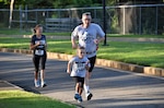 FORT BELVOIR, Va. (June 24, 2015) Alex Absher, 5, races to beat his father, Defense Threat Reduction Agency employee Lennol Absher, during the "fun" run/walk at the 2015 McNamara Headquarters Complex's Family Day June 24. More than 100 participants competed in the race, sponsored by the HQC Fitness Center. 