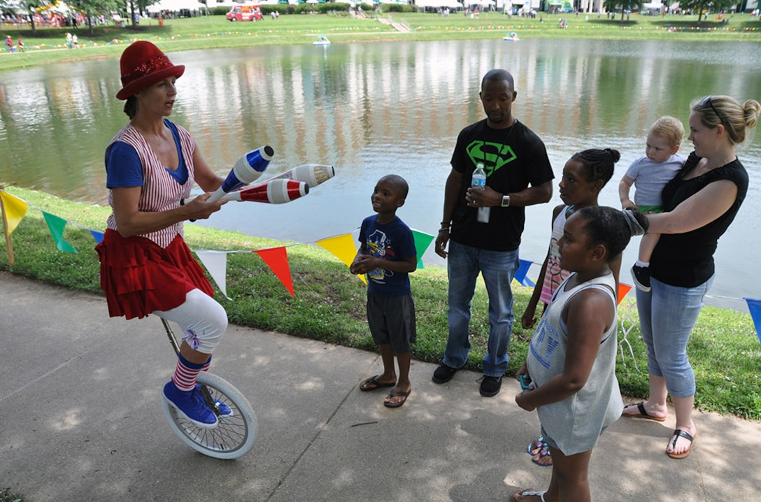 FORT BELVOIR, Va. (June 24, 2015) A juggler performs for 9-year-old Xandria Wickes (right) and her family during the 2015 HQC Family Day June 24 at the McNamara Headquarters Complex. More than 7,500 people attended the event, sponsored by the HQC's Morale, Welfare and Recreation program office.