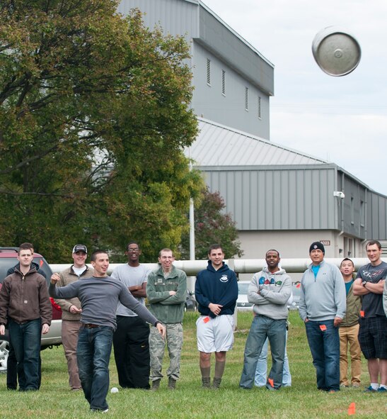National Air and Space Intelligence Center staff members compete in a keg toss contest during the center's 47th Annual Oktoberfest celebration at Bass Lake, Oct. 2, 2015. NASIC Airmen compete in Oktoberfest Cup competitions to earn center bragging rights; events consist of a keg toss, log sawing contest, beer jug relay, and beer tasting. (U.S. Air Force photo by Senior Airman Samuel Earick)