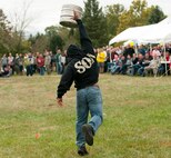 Master Sgt. John Kennedy, National Air and Space Intelligence Center first sergeant, competes in the keg toss during the center's 47th Annual Oktoberfest celebration at Bass Lake, Oct. 2, 2015. NASIC Airmen compete in Oktoberfest Cup competitions to earn center bragging rights; events consist of a keg toss, log sawing contest, beer jug relay, and beer tasting. (U.S. Air Force photo by Senior Airman Samuel Earick)
