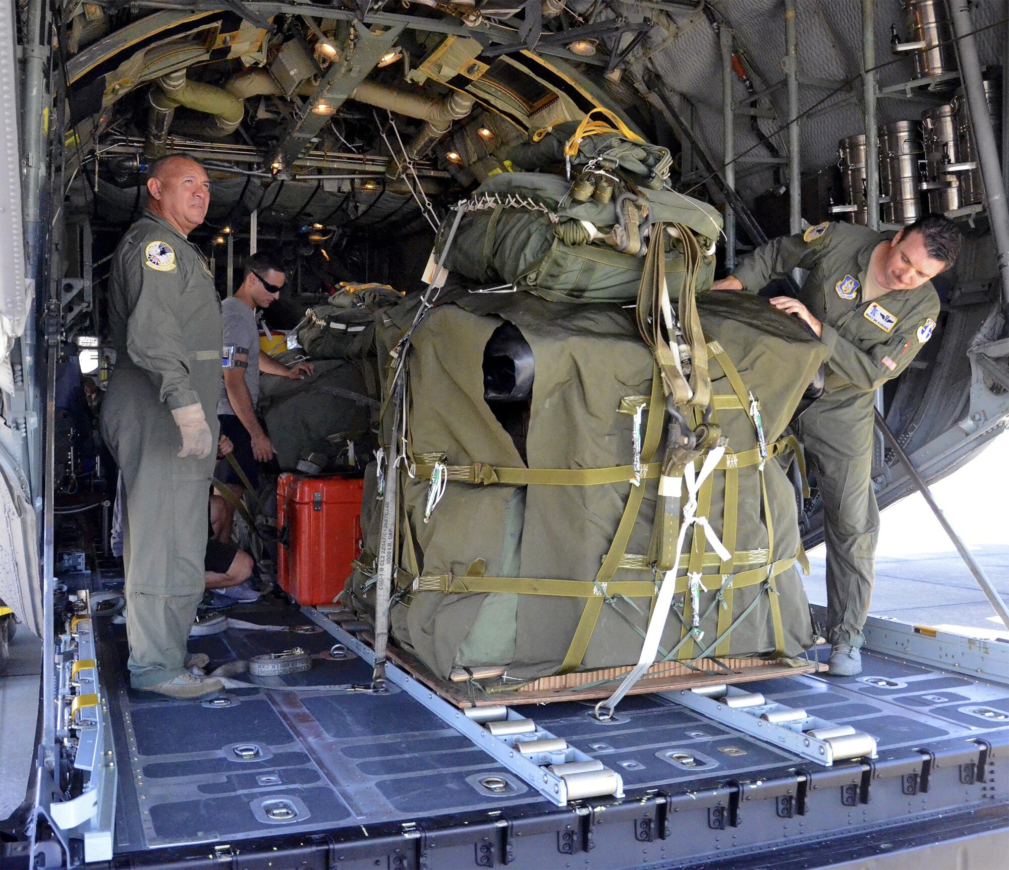 Loadmastsers with the 920th Rescue Wing inspect two RAMZ packs (Rigged Alternate Method Zodiac) in the back of a wing HC-130P/N King aircraft prior to a search-and-rescue mission. The packs each contain an inflatable Zodiac boat, an oxygen tank to inflate the boat, an outboard motor for the boat and medical equipment. When a survivor is spotted in the ocean, the RAMZ are pushed from the rear of the aircraft to parachute into the sea below. A team of pararescuemen follow, and once they’ve parachuted into the ocean, they assemble the RAMZ and use it to reach and rescue the survivor. (U.S. Air Force photo/Master Sgt. Paul Flipse) 
