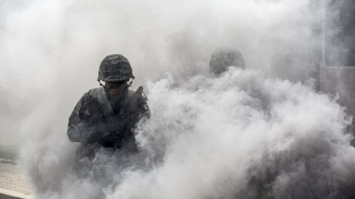 Republic of Korea Marine Lance Cpl. Sunghyun Lee practices urban operations alongside U.S. Marines under smoke concealment during Korean Marine Exchange Program 15-12 at Gunha-Rhi, Gimpo, Republic of Korea, Sept. 17, 2015. KMEP 15-12 is a bilateral training exercise that enhances the ROK and U.S. alliance, promotes stability on the Korean Peninsula and strengthens ROK and U.S. military capabilities and interoperability. Lee, from Cheonan, ROK, is a rifleman with 1st Company, 11th Battalion, 1st Regiment, 2nd Marine Division. The U.S. Marines are with Fox Company, 2nd Battalion, 3rd Marine Regiment, currently assigned to 4th Marine Regiment, 3rd Marine Division, III Marine Expeditionary Force under the unit deployment program. (U.S. Marine Corps photo by Cpl. Tyler S. Giguere/ Released)