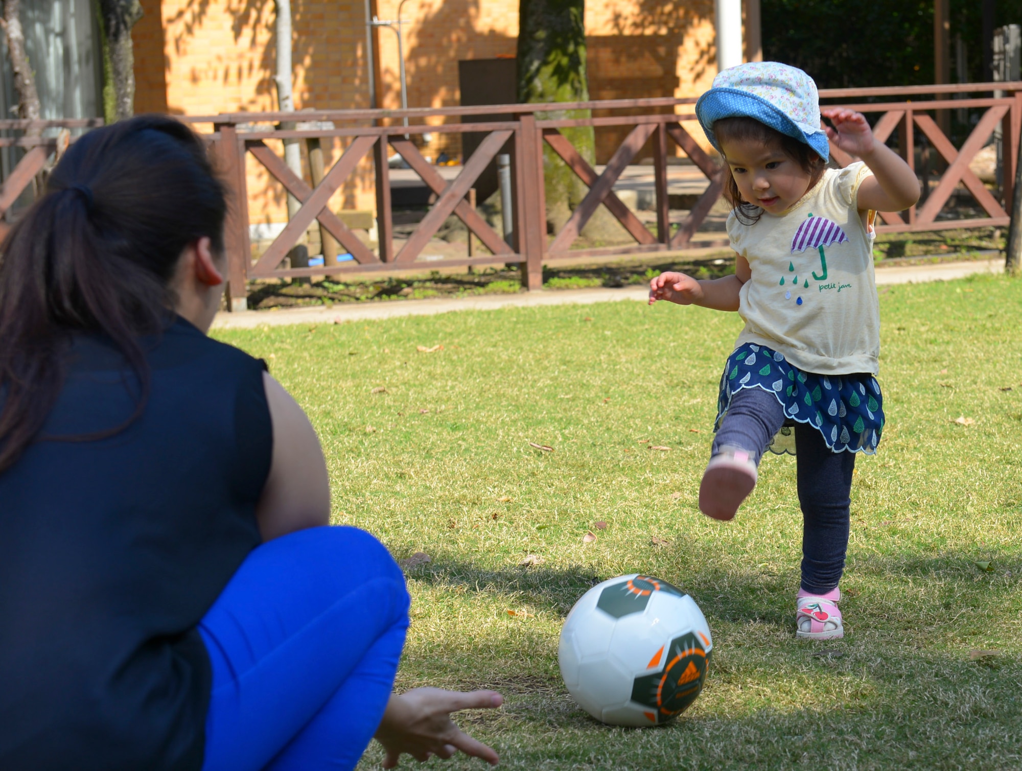 Meri, a child at Shisei Gakuen orphanage, plays with Senior Airman Alexandra Walsh, 374th Airlift Wing paralegal, in Tokyo, Japan, Oct. 3, 2015. Yokota volunteers provided food, friendship and entertainment for the children at Shisei Gakuen.  (U.S. Air Force photo by Airman 1st Class Elizabeth Baker/Released)