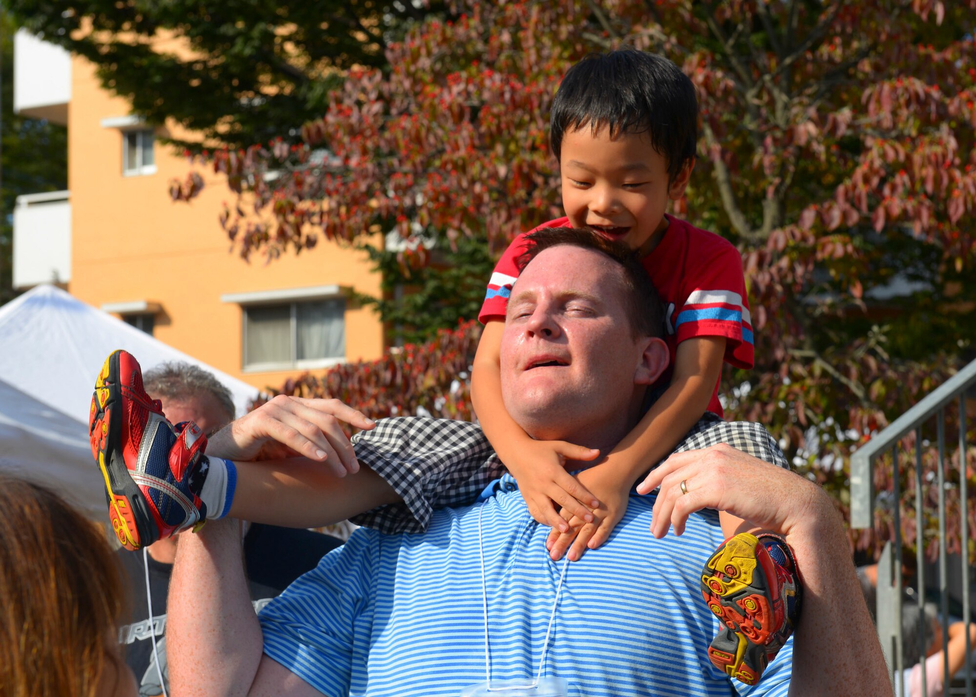 Matthew Newburn, 374th Force Support Squadron supervisory human resources specialist, plays with a child at Shisei Gakuen orphanage in Tokyo, Japan, Oct. 3, 2015. Yokota personnel and their families demonstrated service before self in the local community by spending a day volunteering and making friends at Shisei Gakuen. (U.S. Air Force photo by Airman 1st Class Elizabeth Baker/Released)