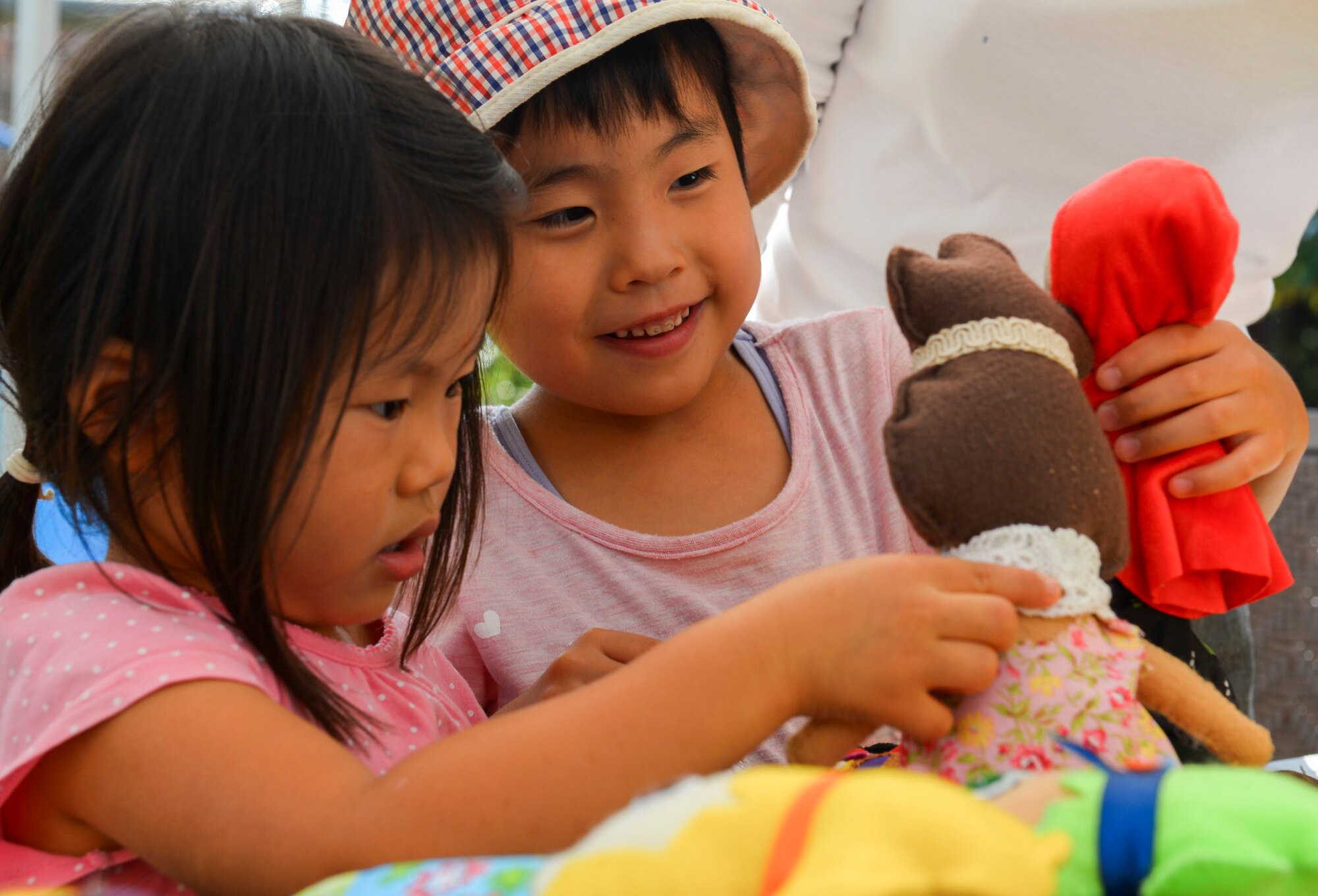 Children at Shisei Gakuen orphanage choose dolls to keep in Tokyo, Japan, Oct. 3, 2015. The family of Tech. Sgt. Angela Mckensie, 374th Force Support Squadron NCO in charge of customer support, made the dolls to distribute to the children. (U.S. Air Force photo by Airman 1st Class Elizabeth Baker/Released)