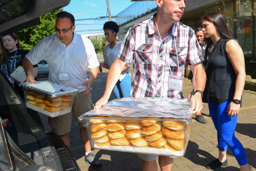 Yokota volunteers set up food while volunteering at Shiseigakuen orphanage in Tokyo, Japan, Oct. 3, 2015. Airmen spent the day serving food, giving out candy and prizes and playing with children at the orphanage. (U.S. Air Force photo by Airman 1st Class Elizabeth Baker/Released)
