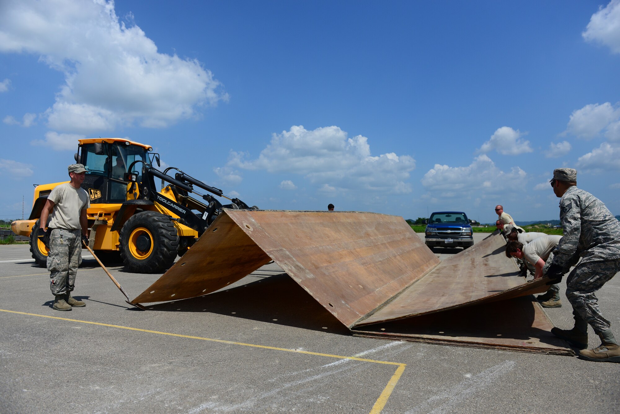Airmen from the 51st Civil Engineer Squadron structures shop unfold a large rapid runway repair fiberglass mat as part of airfield damage-repair drills at Osan Air Base, Republic of Korea, Aug. 18, 2015.  A foreign-object debris mat is anchored over a repaired hole once a crater is refilled and smoothed.
(U.S. Air Force photo/Staff Sgt. Amber Grimm)
