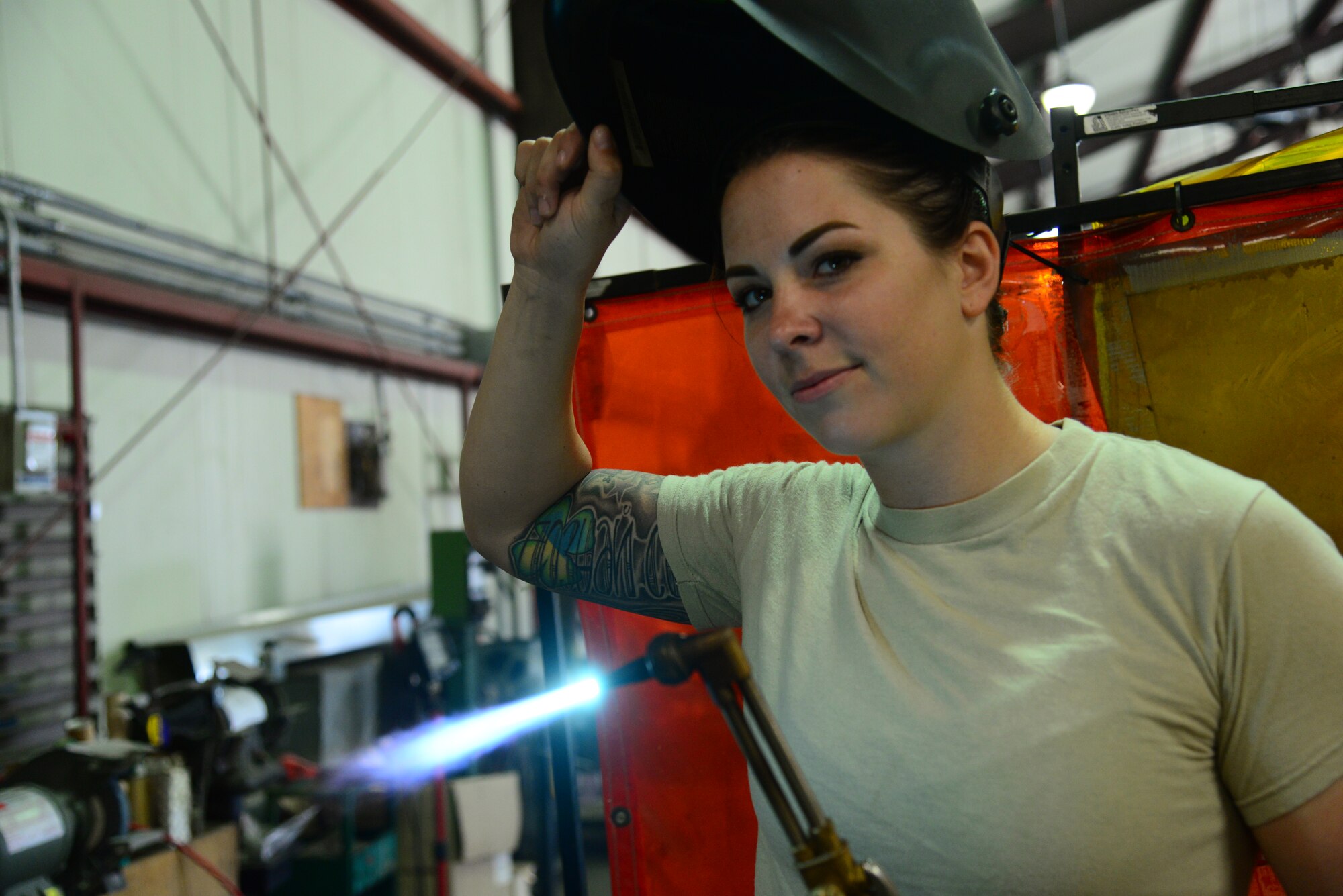 Staff Sgt. Bethanie Jeremenko, a 51st Civil Engineer Squadron structural craftsman, proudly poses holding one of her favorite tools, an industrial blow torch at Osan Air Base, Republic of Korea, July 30, 2015. Whether cutting, painting, welding or building, no job is too big or too small for an Airman of the 51st Civil Engineer Squadron structures shop.
(U.S. Air Force photo/Staff Sgt. Amber Grimm)