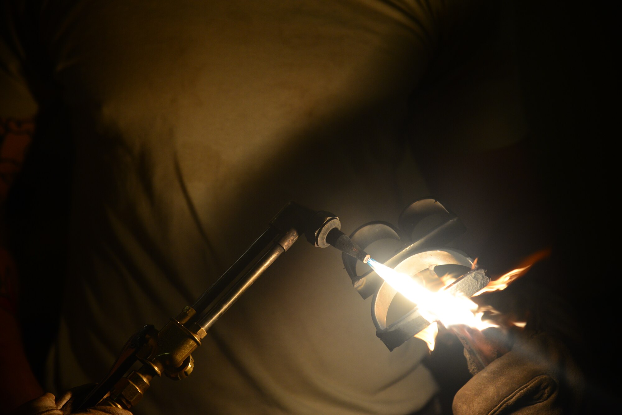 Senior Airman Dale Briggs, 51st Civil Engineer Squadron structural journeyman, uses an industrial blow torch to heat up a brand he designed and created for a special project at Osan Air Base, Republic of Korea, July 30, 2015. A structures troop acts as a functional artisan who can create with a plethora of materials ranging from concrete and carpentry to metal work.
(U.S. Air Force photo/Staff Sgt. Amber Grimm)